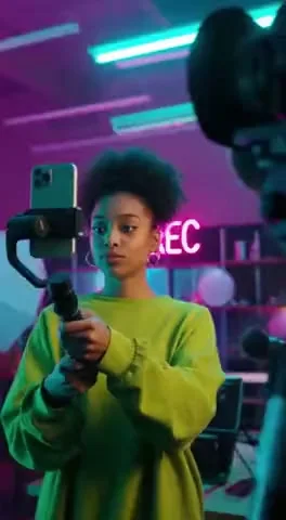 In a bustling urban landscape, the camera glides through a vibrant TikTok studio, where creators passionately film their latest content.